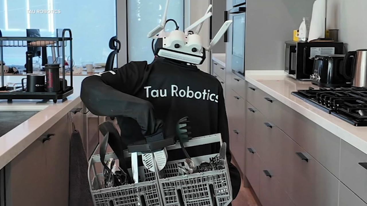 robot humanoidalny siedzący przy stole w nowoczesnym domu